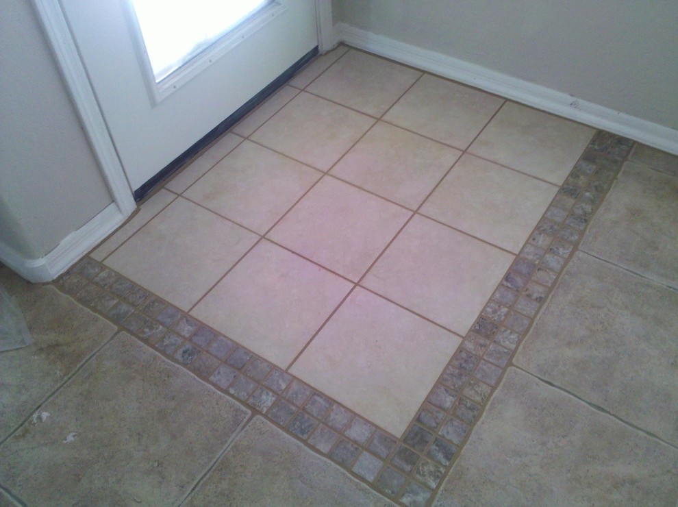 Example of a ceramic tile front door design in Phoenix with beige walls and a white front door