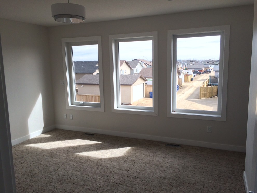 Inspiration for a mid-sized transitional guest carpeted and brown floor bedroom remodel in Calgary with gray walls and no fireplace