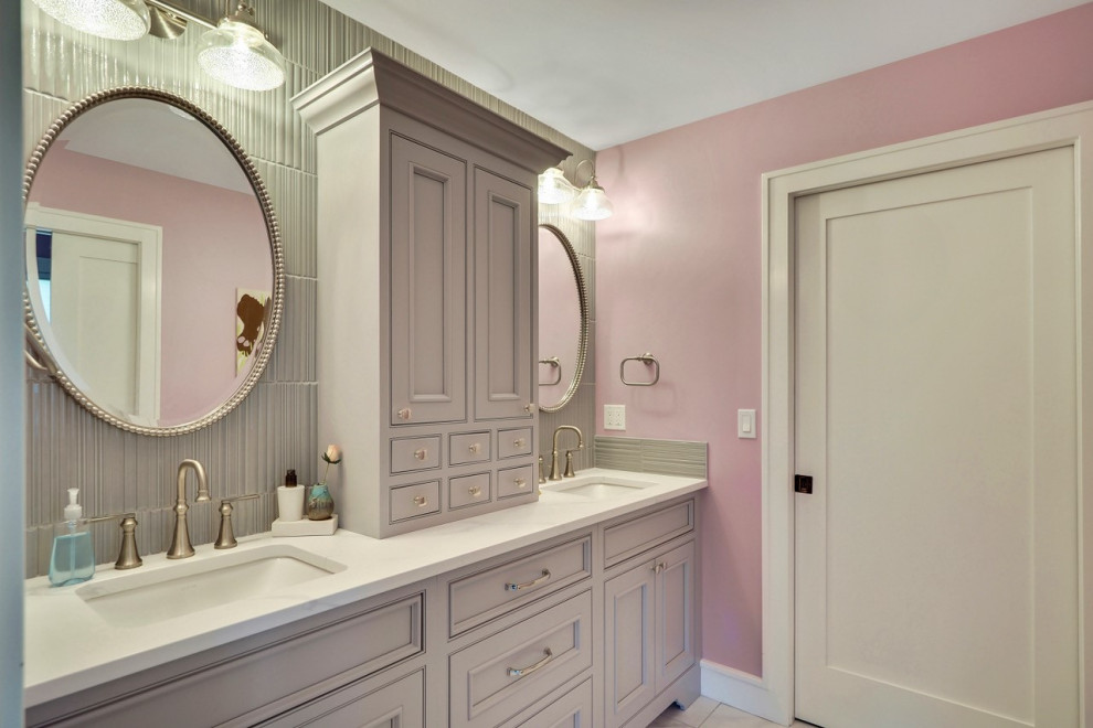 Transitional beige tile and ceramic tile double-sink bathroom photo with granite countertops and black countertops