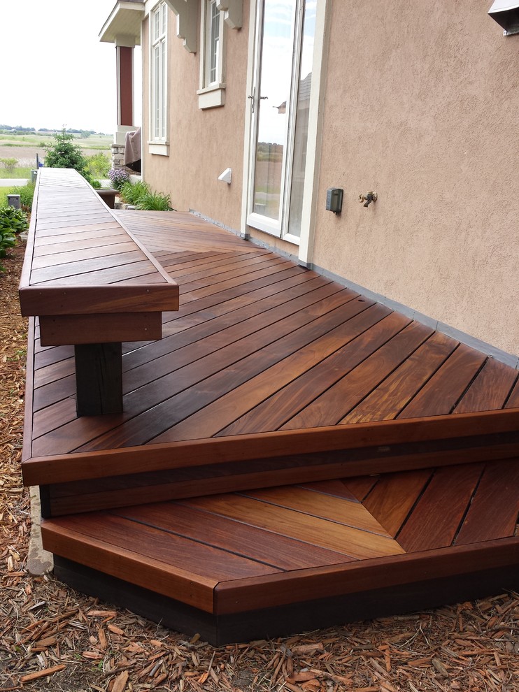 Example of a large transitional backyard deck design in Minneapolis with no cover