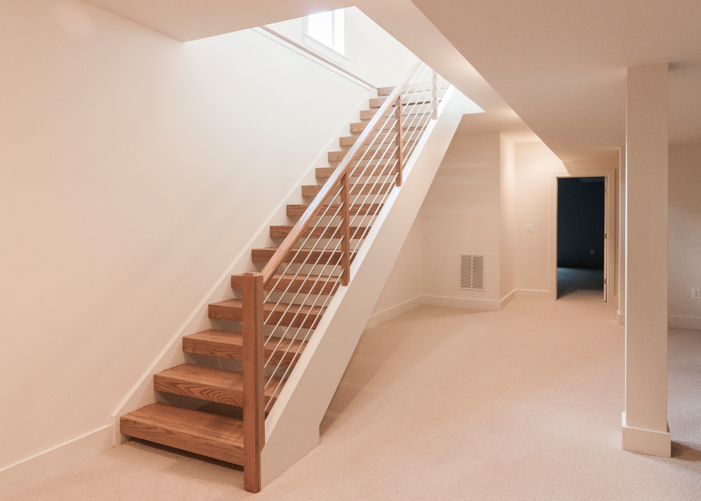 Photo of a large contemporary wood floating staircase in DC Metro with mixed railing.