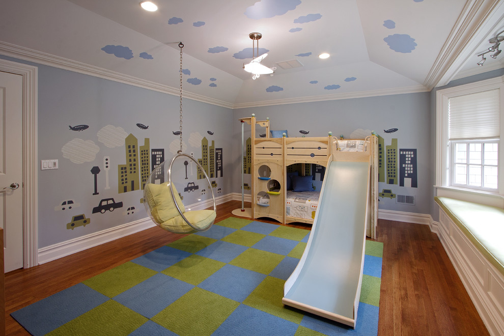 This is an example of a traditional kids' playroom in New York with blue walls, medium hardwood floors and brown floor.