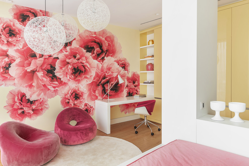 This is an example of a contemporary kids' room for girls in Moscow with multi-coloured walls, light hardwood floors and beige floor.