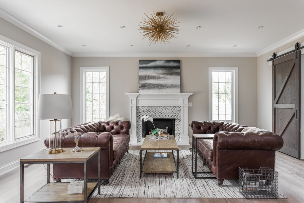 Transitional living room in Indianapolis with beige walls, medium hardwood floors, a standard fireplace, a tile fireplace surround and brown floor.