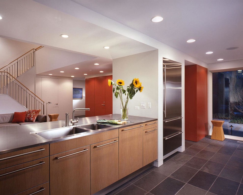 Open concept kitchen - mid-sized transitional u-shaped slate floor and gray floor open concept kitchen idea in Chicago with flat-panel cabinets, medium tone wood cabinets, stainless steel countertops, white backsplash, subway tile backsplash, stainless steel appliances and a peninsula