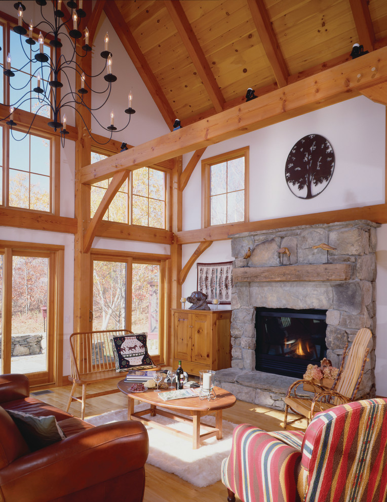 Design ideas for a country open concept living room in Burlington with medium hardwood floors, a standard fireplace and a stone fireplace surround.