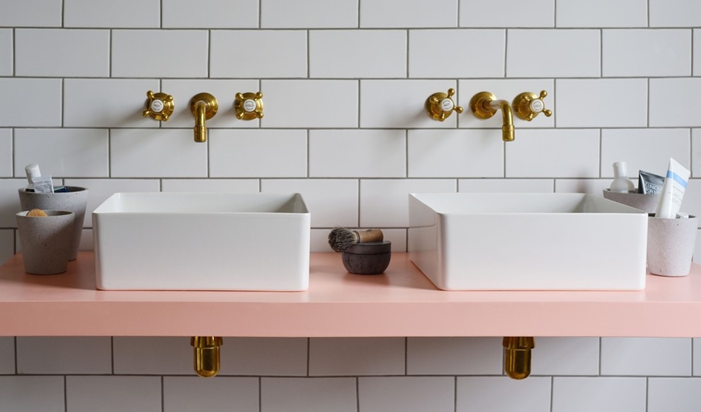 Inspiration for a mid-sized traditional kids bathroom in London with raised-panel cabinets, medium wood cabinets, a claw-foot tub, an open shower, a one-piece toilet, white tile, ceramic tile, white walls, ceramic floors, a trough sink, solid surface benchtops, multi-coloured floor and an open shower.