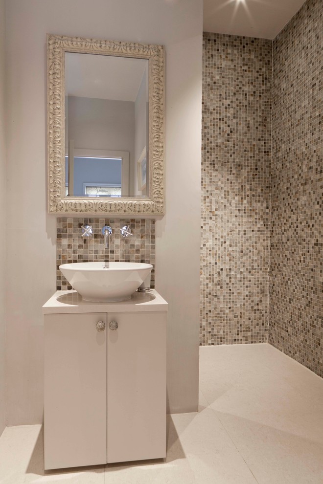 Contemporary bathroom in London with a vessel sink, flat-panel cabinets, white cabinets, beige tile, mosaic tile, beige walls and a curbless shower.