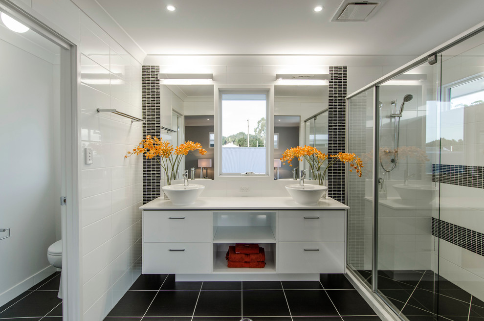 Photo of a mid-sized contemporary master bathroom in Brisbane with white cabinets, quartzite benchtops, an alcove shower, white tile, ceramic tile, white walls, ceramic floors, a vessel sink and flat-panel cabinets.