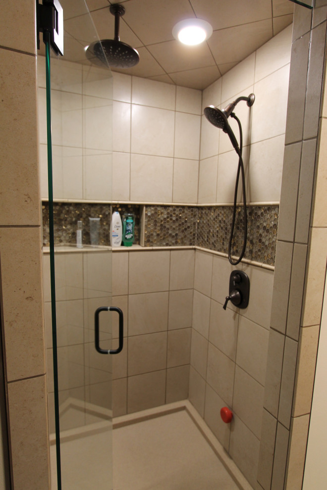 Example of a large mountain style master beige tile and ceramic tile wet room design with an undermount sink, a hinged shower door and multicolored countertops