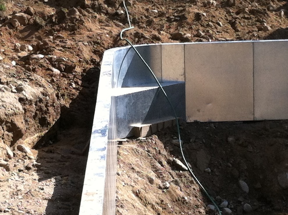 Example of a mid-sized backyard brick and rectangular pool design
