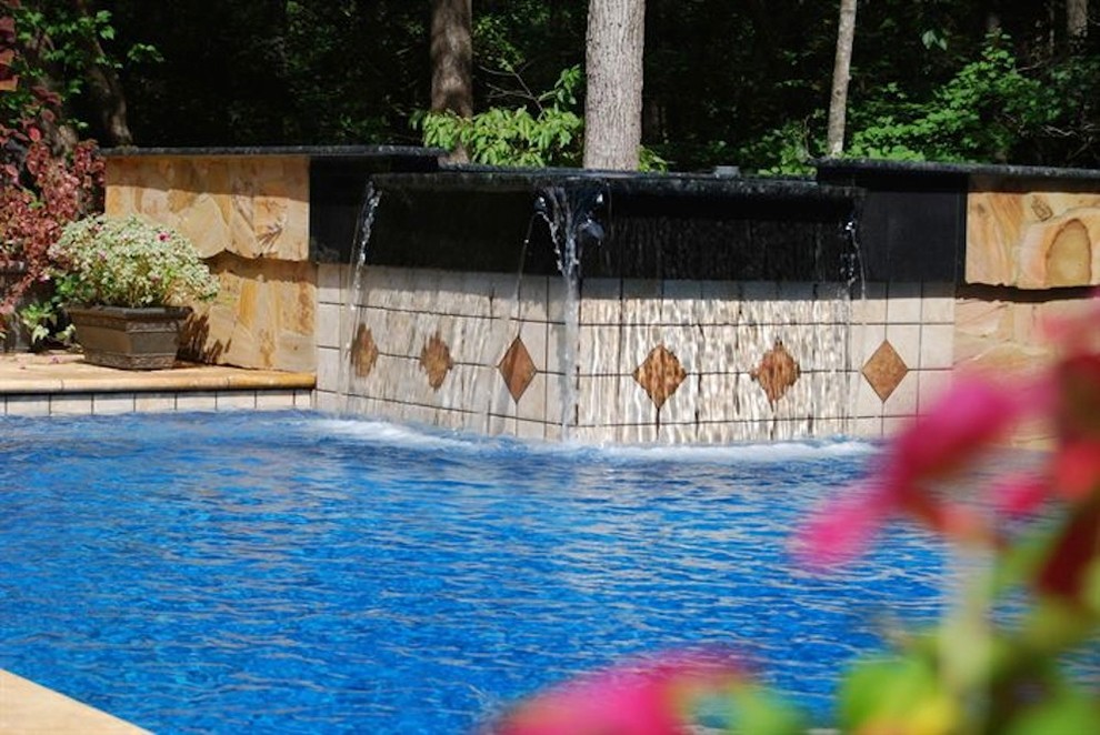 Inspiration for a mid-sized backyard stone and rectangular natural pool fountain remodel