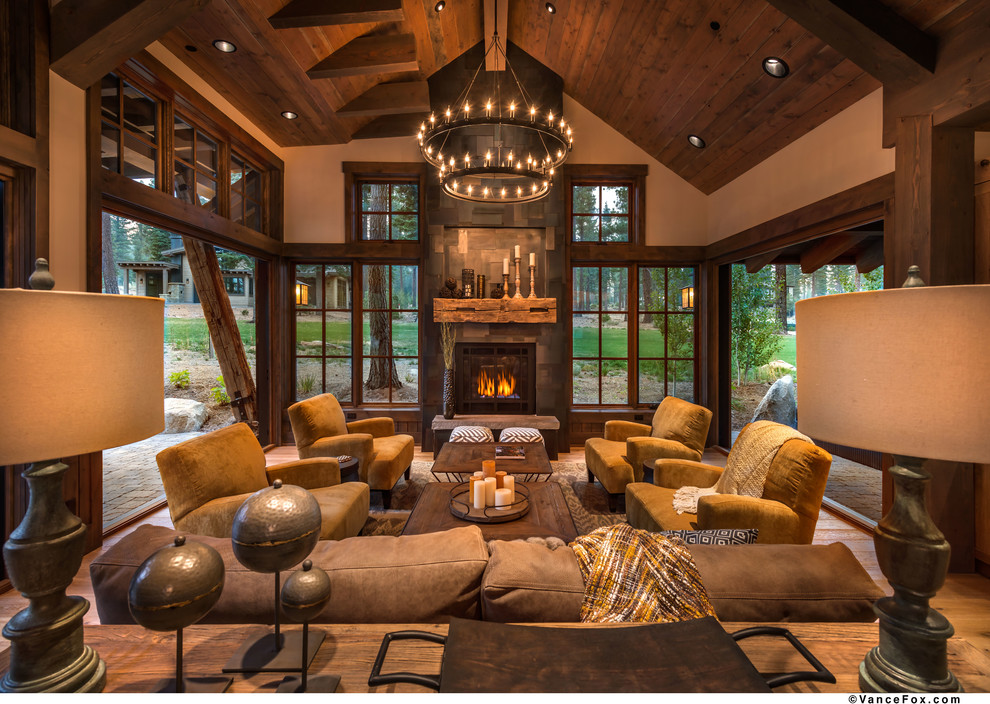 Inspiration for a mid-sized country open concept family room in Sacramento with beige walls, medium hardwood floors, a standard fireplace, a tile fireplace surround and no tv.