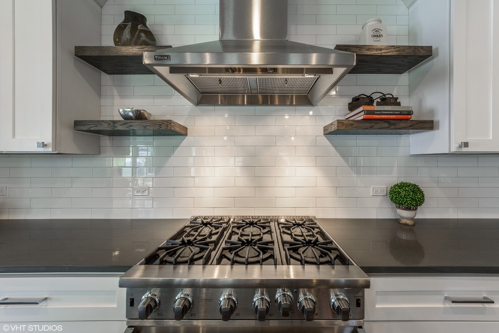 Inspiration for a mid-sized transitional single-wall dark wood floor and brown floor open concept kitchen remodel in Chicago with an undermount sink, shaker cabinets, white cabinets, quartz countertops, white backsplash, porcelain backsplash, stainless steel appliances, an island and gray countertops