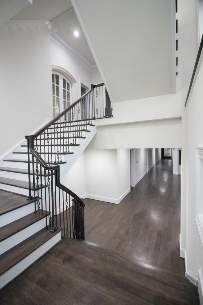Inspiration for a large transitional wood floating staircase in DC Metro with wood risers and glass railing.