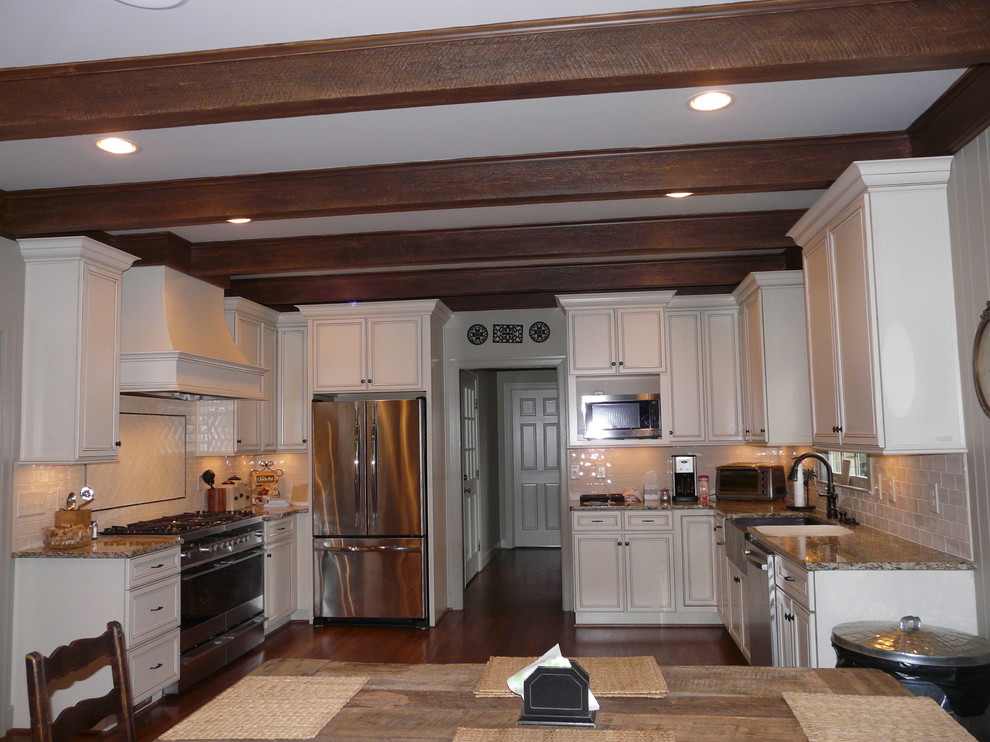 Transitional eat-in kitchen photo in Birmingham with a farmhouse sink, flat-panel cabinets, granite countertops, porcelain backsplash and stainless steel appliances