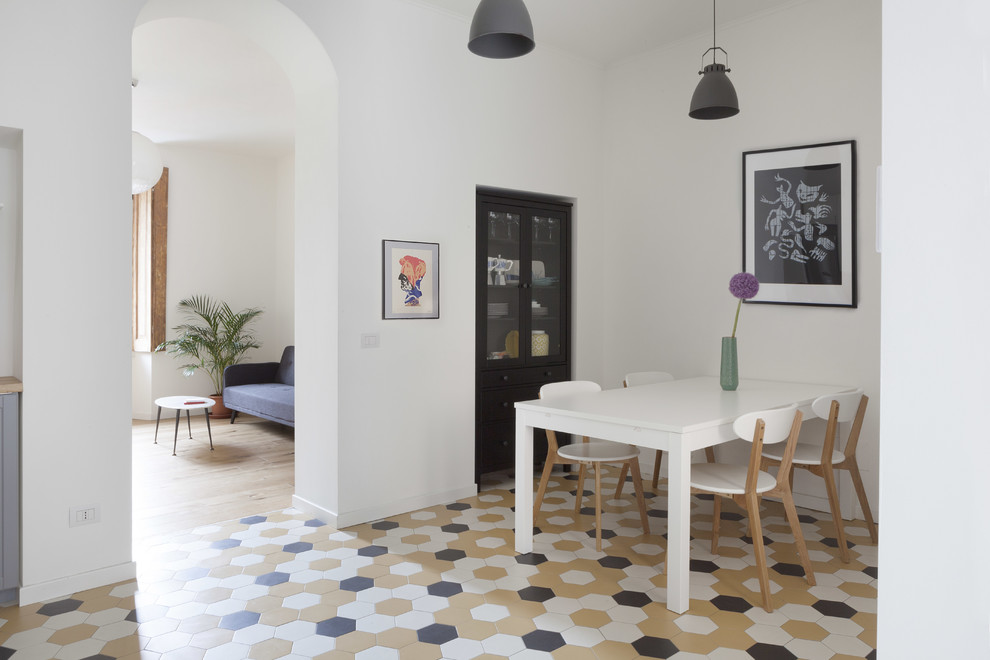 Photo of a small scandinavian open plan dining in Milan with white walls, ceramic floors and multi-coloured floor.