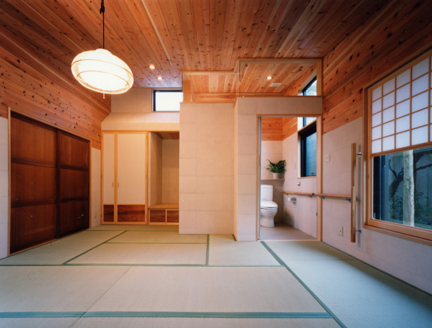 Photo of a large modern master bedroom in Other with white walls, tatami floors, wood and wood walls.