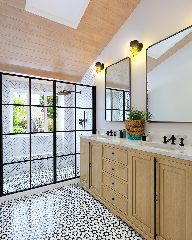 Photo of a scandinavian bathroom in San Diego with raised-panel cabinets, light wood cabinets, an alcove shower, white tile, white walls, an undermount sink, multi-coloured floor, a sliding shower screen and grey benchtops.