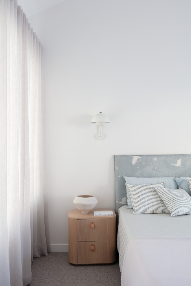 This is an example of a contemporary bedroom in Brisbane.