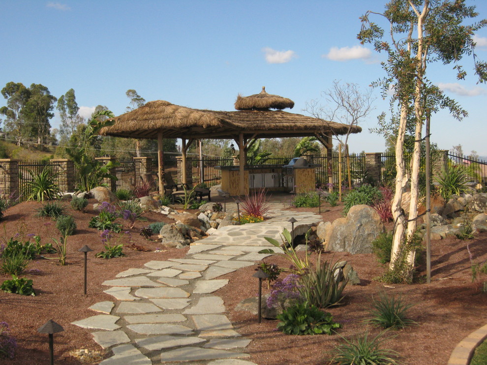This is an example of a tropical backyard garden in San Diego.