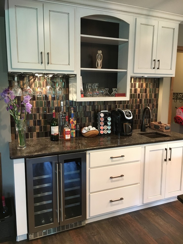 This is an example of a small contemporary single-wall wet bar in Other with an undermount sink, flat-panel cabinets, white cabinets, quartzite benchtops, multi-coloured splashback, glass tile splashback, dark hardwood floors, brown floor and multi-coloured benchtop.