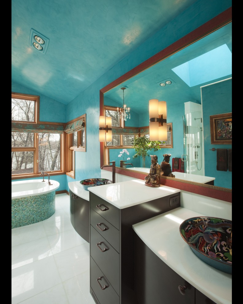 Large eclectic master blue tile and mosaic tile bathroom photo in Minneapolis with a vessel sink, flat-panel cabinets, dark wood cabinets, onyx countertops, a bidet and blue walls