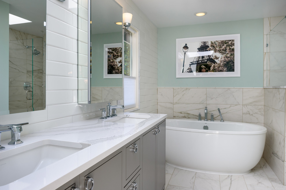 Mid-sized contemporary 3/4 bathroom in Seattle with flat-panel cabinets, grey cabinets, a freestanding tub, a corner shower, white tile, subway tile, grey walls, marble floors, an undermount sink, marble benchtops, white floor and a hinged shower door.