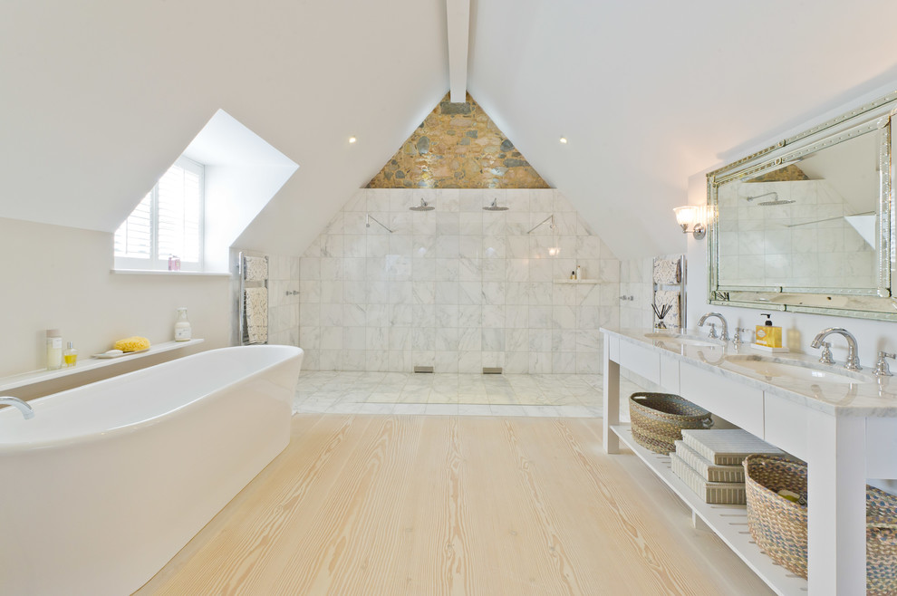 Design ideas for a mid-sized scandinavian bathroom in Channel Islands with an undermount sink, white cabinets, a freestanding tub, white walls, light hardwood floors and a curbless shower.