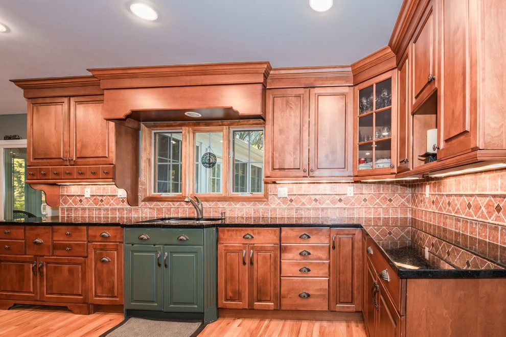 This is an example of a large contemporary galley kitchen pantry in New York with a drop-in sink, raised-panel cabinets, medium wood cabinets, laminate benchtops, beige splashback, stone tile splashback, stainless steel appliances, medium hardwood floors, no island, brown floor and multi-coloured benchtop.