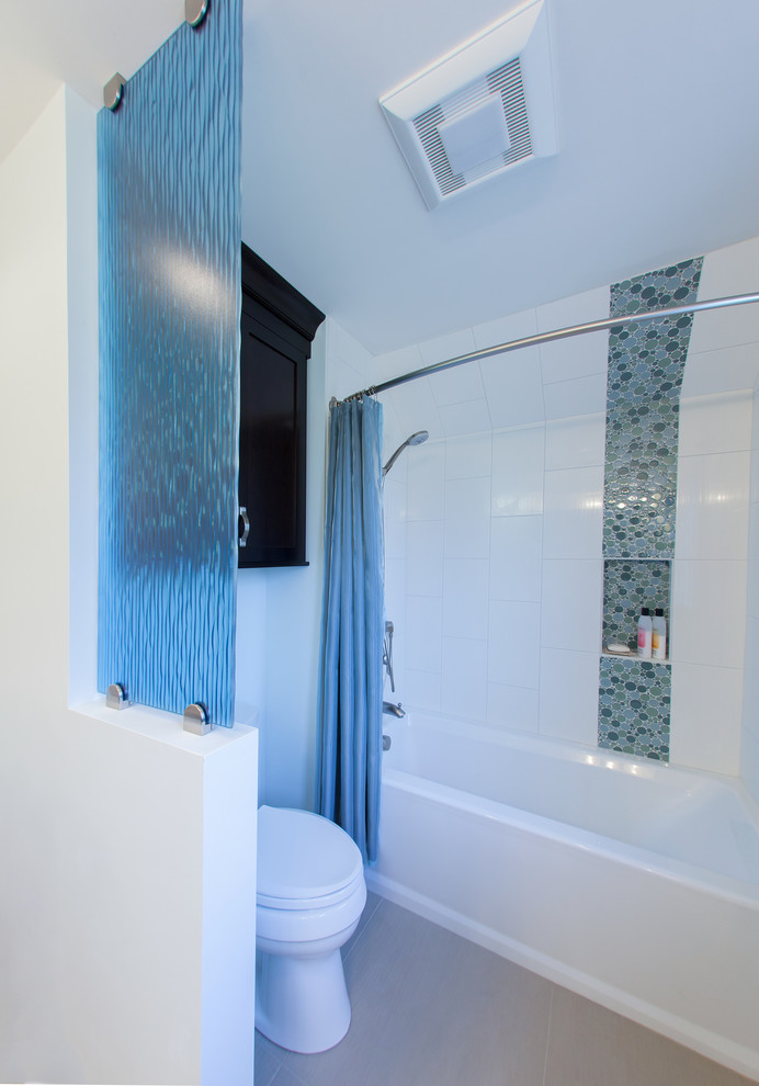 Transitional blue tile and glass sheet porcelain tile tub/shower combo photo in Seattle with an undermount sink, shaker cabinets, dark wood cabinets, quartzite countertops, a one-piece toilet and white walls