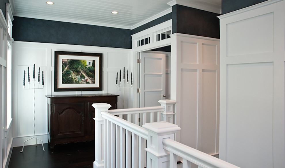 Inspiration for a mid-sized beach style hallway in Other with white walls, dark hardwood floors and brown floor.