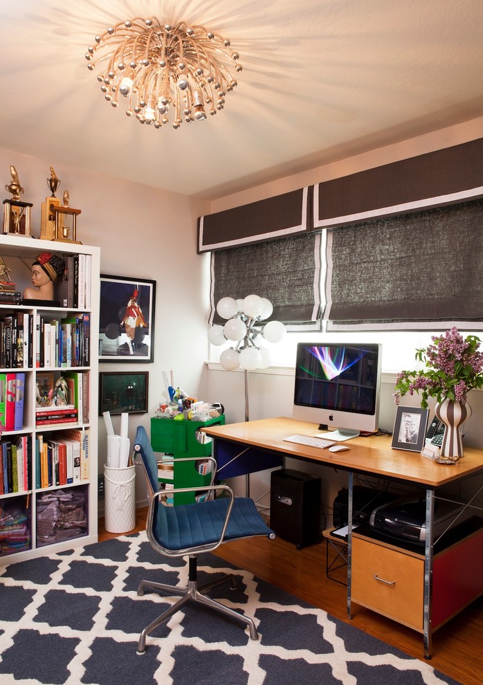 Eclectic home office in San Francisco with white walls, medium hardwood floors and a freestanding desk.