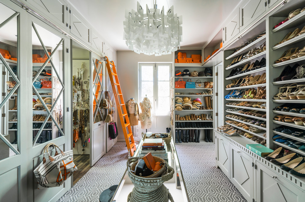 Inspiration for a transitional women's dressing room in Atlanta with open cabinets, grey cabinets, carpet and grey floor.