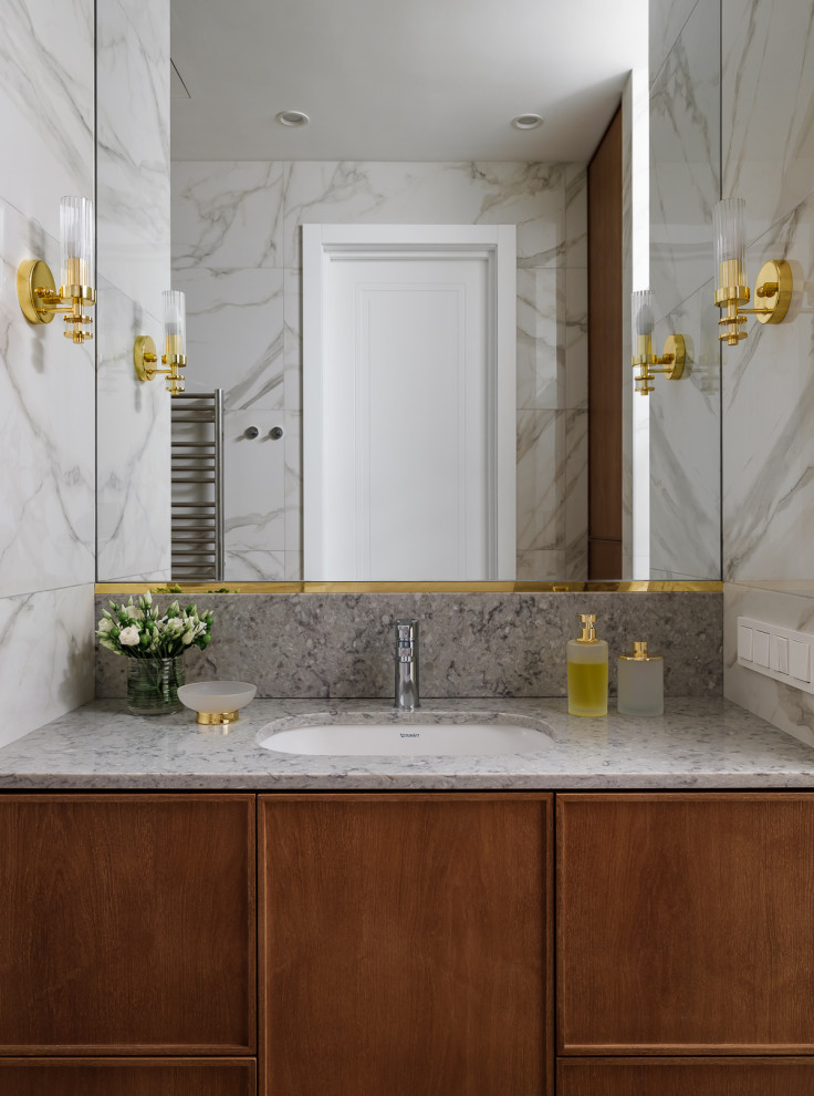 Example of a mid-sized trendy 3/4 white tile and marble tile wood-look tile floor, brown floor, single-sink and wainscoting bathroom design in Moscow with recessed-panel cabinets, white cabinets, a wall-mount toilet, white walls, an undermount sink, quartz countertops, a hinged shower door, gray countertops and a floating vanity