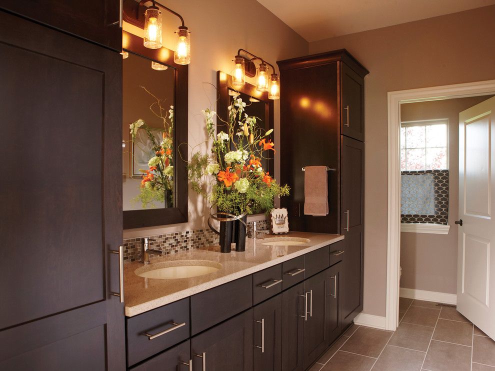 This is an example of a mid-sized transitional master bathroom in Milwaukee with flat-panel cabinets, dark wood cabinets, an alcove shower, a two-piece toilet, gray tile, ceramic tile, grey walls, ceramic floors, an undermount sink and engineered quartz benchtops.