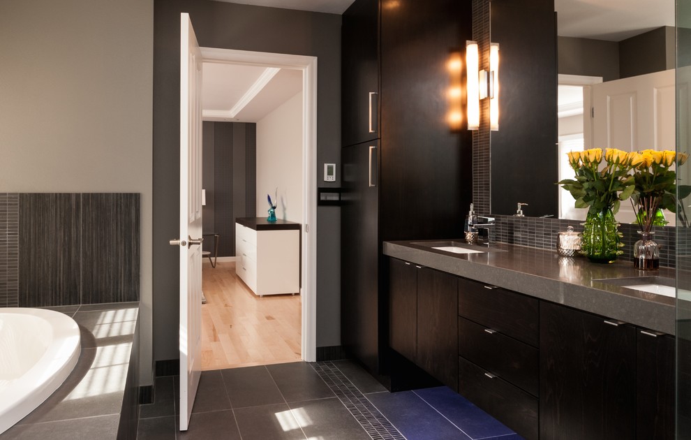 Large master gray tile drop-in bathtub photo in Seattle with black cabinets