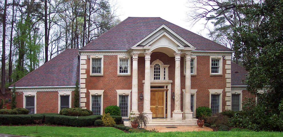 This is an example of an expansive traditional two-storey brick red exterior in Atlanta with a hip roof.