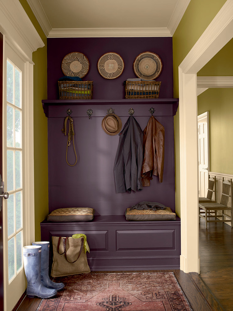Photo of a traditional mudroom with green walls.
