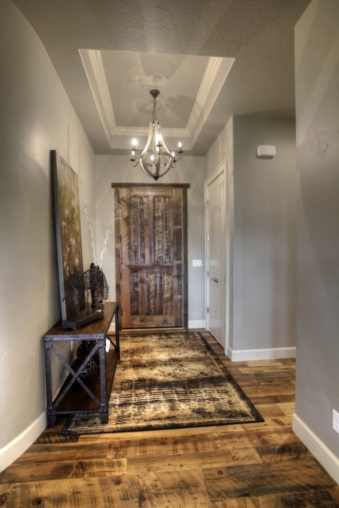 Foyer - mid-sized transitional medium tone wood floor and brown floor foyer idea in Boise with gray walls and a dark wood front door