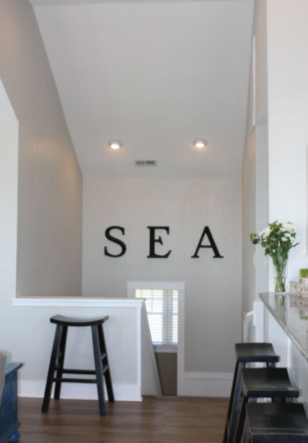 Small beach style hallway in Other with beige walls.