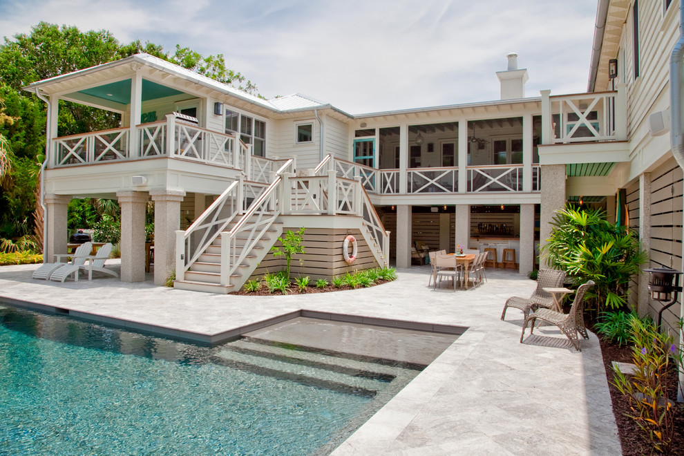 Design ideas for a beach style two-storey white exterior in Charleston.