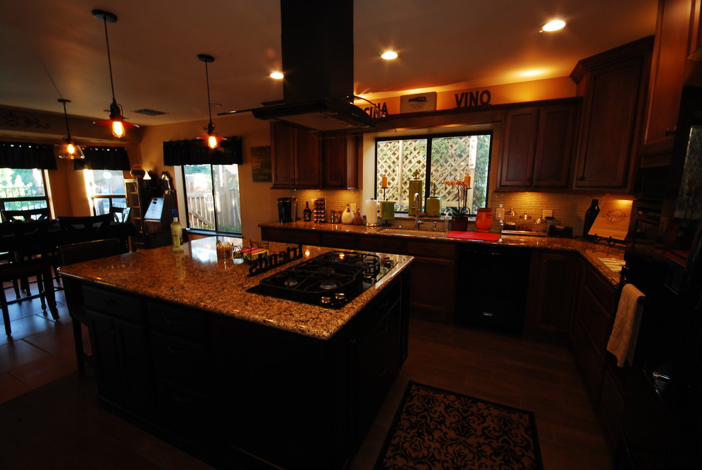 Eat-in kitchen - traditional u-shaped eat-in kitchen idea with an undermount sink, shaker cabinets, brown cabinets, quartz countertops, beige backsplash, glass sheet backsplash and black appliances
