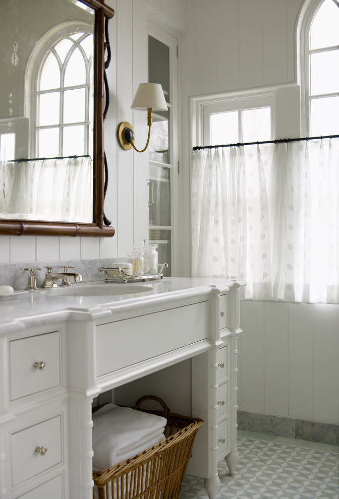 Inspiration for a mid-sized country 3/4 bathroom in Bridgeport with white cabinets, white walls, porcelain floors, beaded inset cabinets and a drop-in sink.