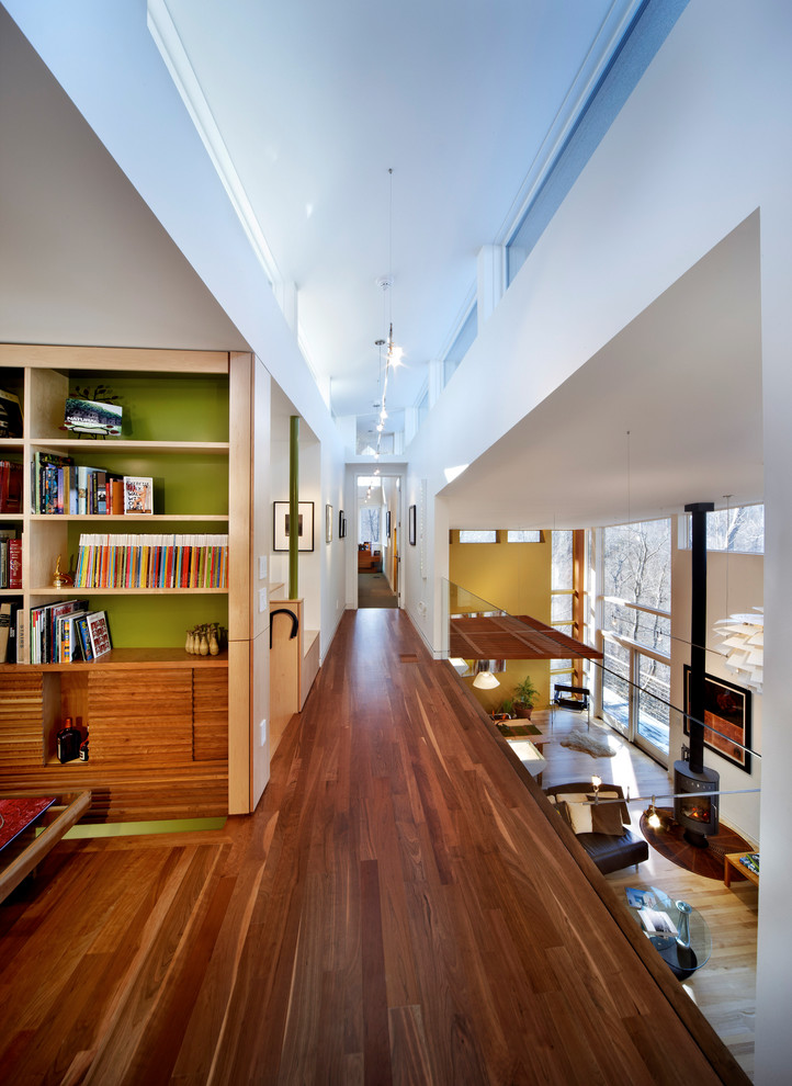 This is an example of a contemporary hallway in Raleigh with dark hardwood floors.