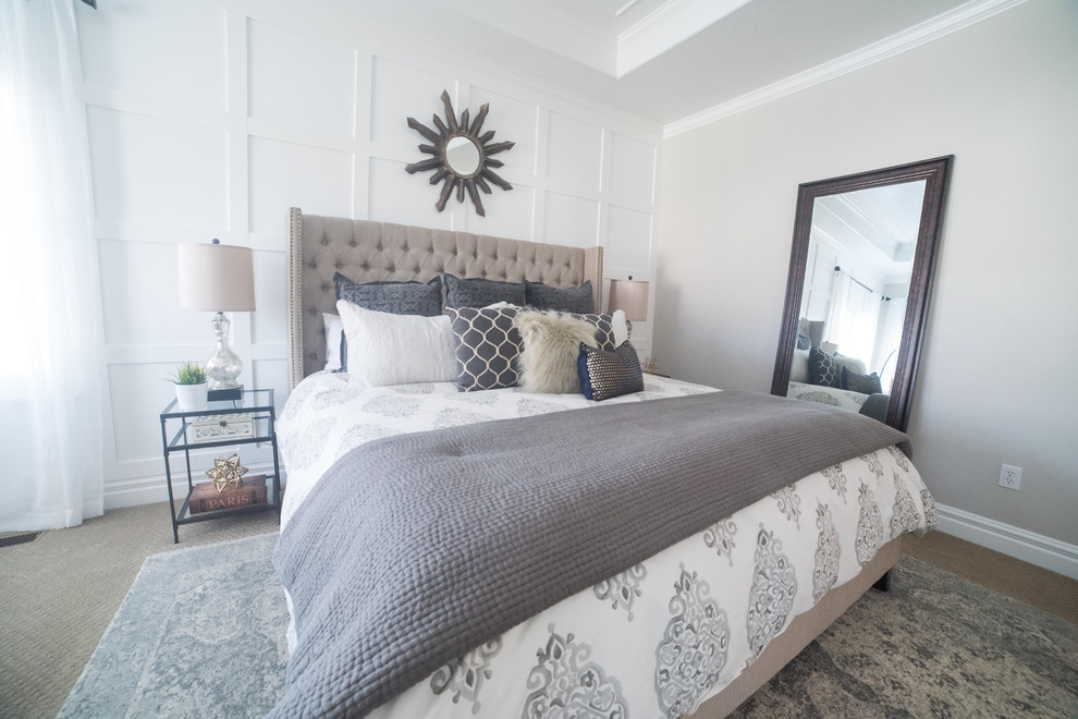 Large transitional master bedroom in Salt Lake City with grey walls, carpet and a wood fireplace surround.
