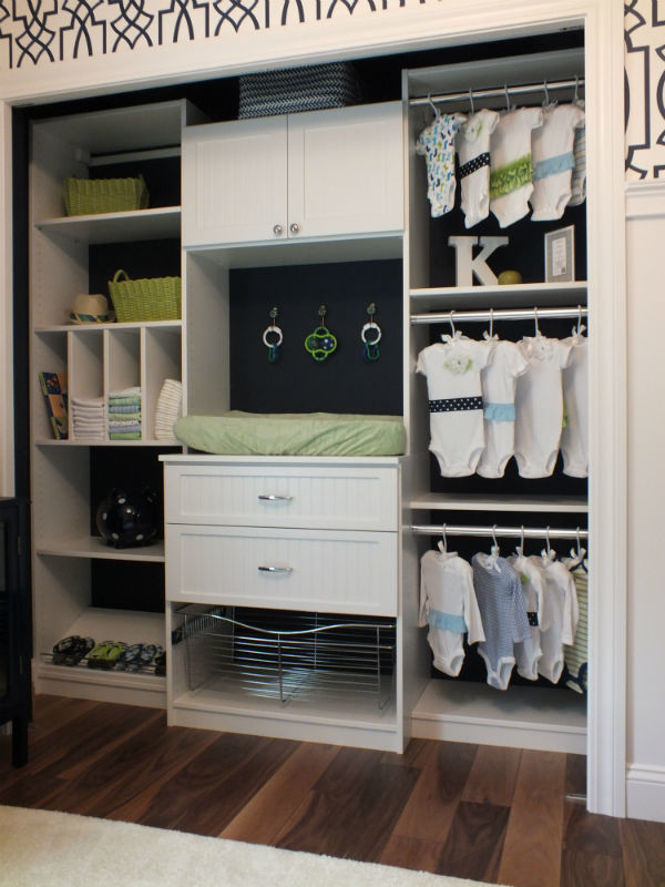 This is an example of a mid-sized traditional gender-neutral built-in wardrobe in Cleveland with white cabinets and dark hardwood floors.