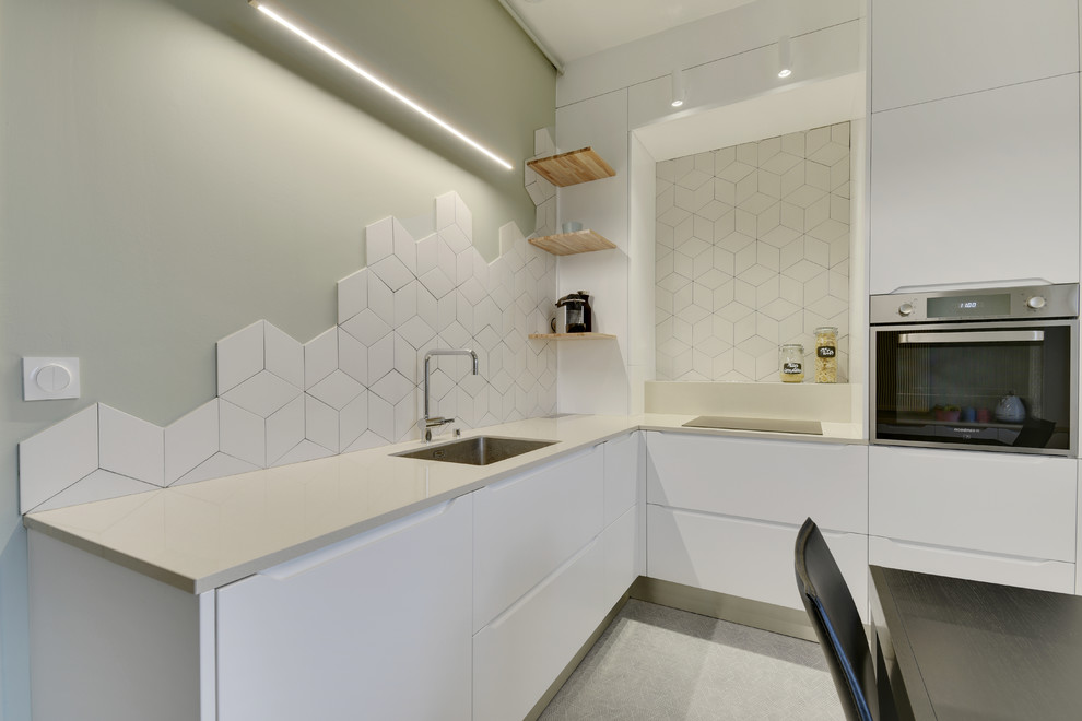 This is an example of a mid-sized modern l-shaped separate kitchen in Bordeaux with white cabinets, quartzite benchtops, white splashback, ceramic splashback, panelled appliances, linoleum floors, no island, grey floor, beige benchtop, an undermount sink and flat-panel cabinets.