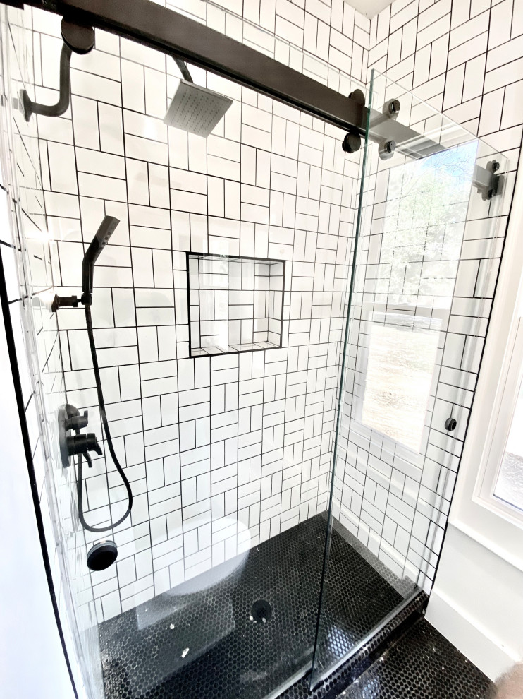 This is an example of a transitional bathroom in Other with an alcove shower and a sliding shower screen.