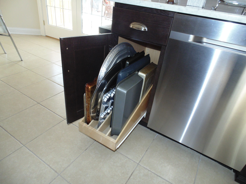 Example of a mid-sized transitional u-shaped ceramic tile and beige floor kitchen design with an undermount sink, raised-panel cabinets, dark wood cabinets, quartz countertops, beige backsplash, subway tile backsplash, stainless steel appliances and beige countertops